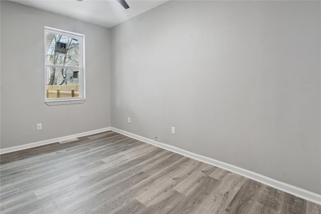 empty room featuring light hardwood / wood-style flooring and ceiling fan