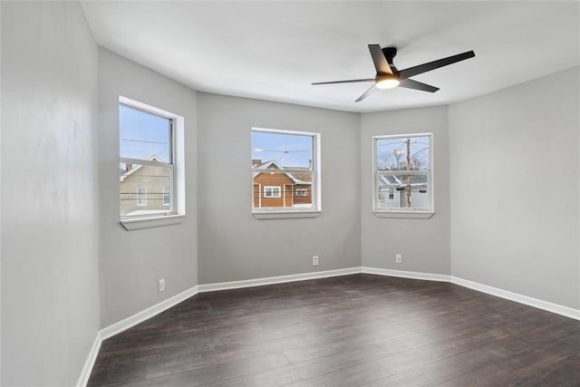 spare room featuring ceiling fan and dark hardwood / wood-style flooring