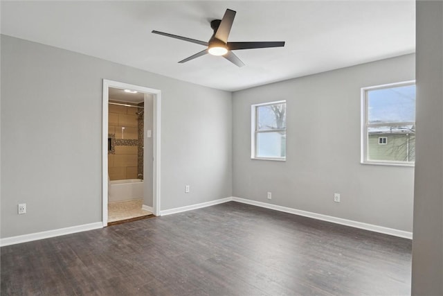 unfurnished room with a wealth of natural light, dark hardwood / wood-style flooring, and ceiling fan