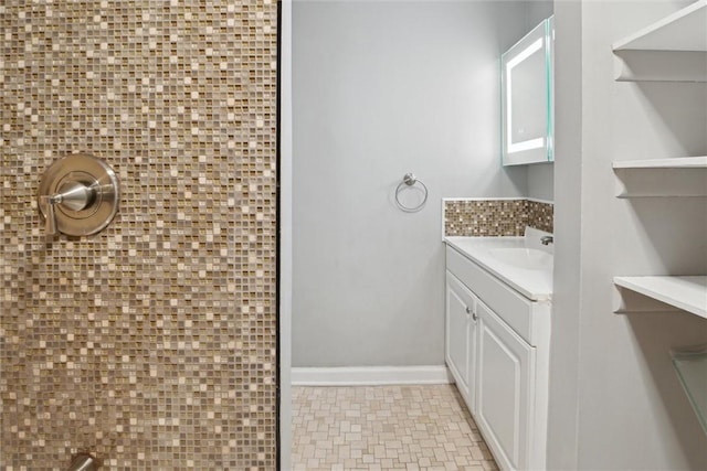 bathroom featuring vanity and backsplash