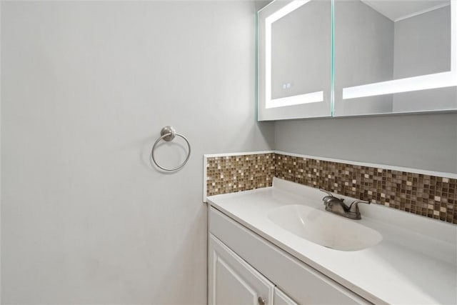 bathroom featuring tasteful backsplash and vanity