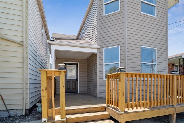 view of exterior entry with a deck
