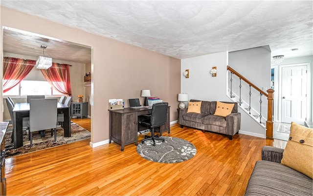 living room with hardwood / wood-style floors and a textured ceiling