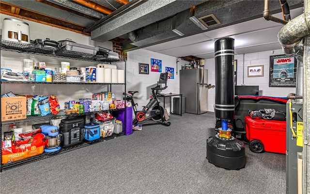 basement with stainless steel refrigerator