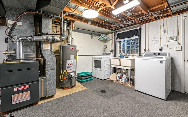 basement featuring carpet, sink, gas water heater, and washing machine and clothes dryer