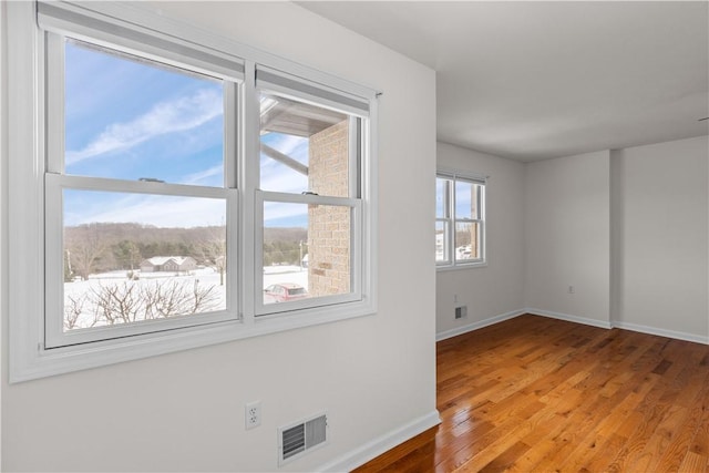 spare room with hardwood / wood-style floors