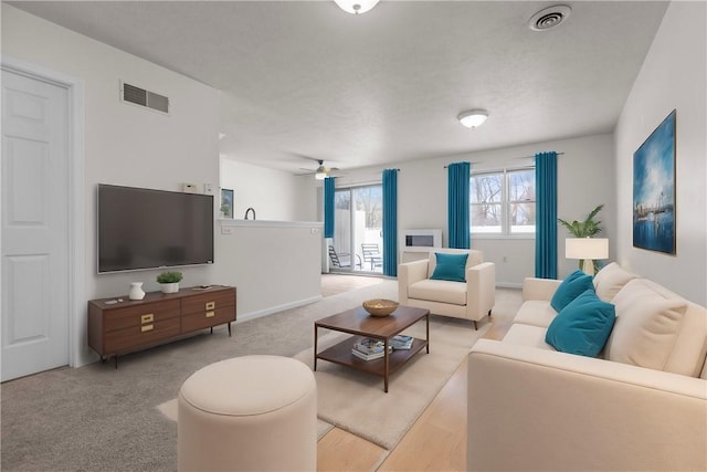 living room with light carpet and ceiling fan