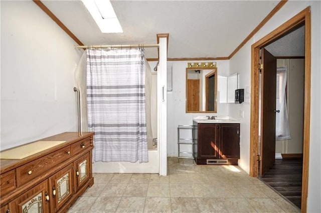 bathroom with vanity, shower / bathtub combination with curtain, ornamental molding, and vaulted ceiling