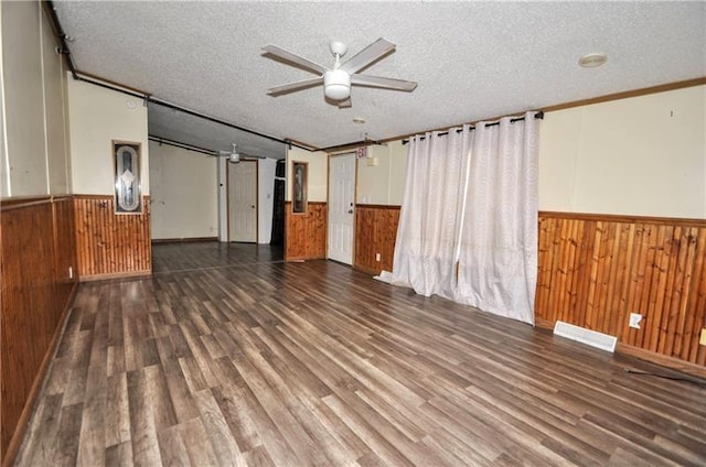 empty room featuring ceiling fan, crown molding, and a textured ceiling