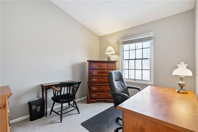 office space with light carpet, plenty of natural light, and lofted ceiling