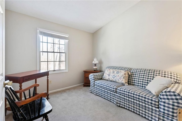 sitting room with lofted ceiling and light carpet