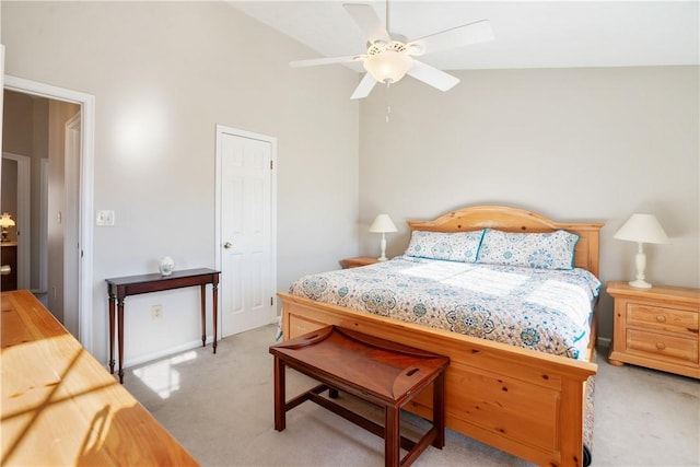 bedroom with ceiling fan, lofted ceiling, and light carpet