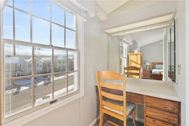 home office featuring lofted ceiling