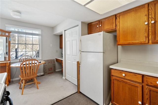 kitchen featuring white fridge and light colored carpet