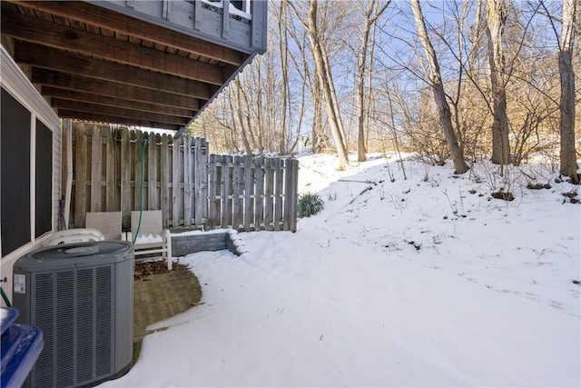 yard covered in snow featuring cooling unit