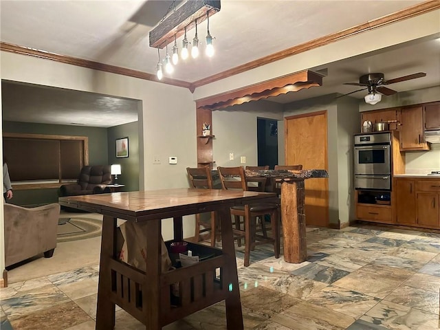 dining space featuring crown molding and ceiling fan