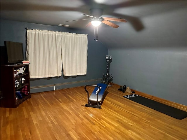 exercise area featuring hardwood / wood-style floors, ceiling fan, and vaulted ceiling