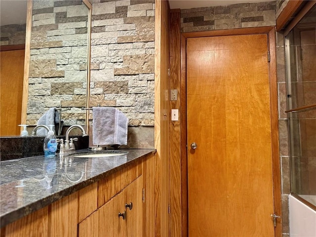 interior space featuring vanity and  shower combination