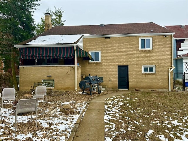 view of snow covered rear of property