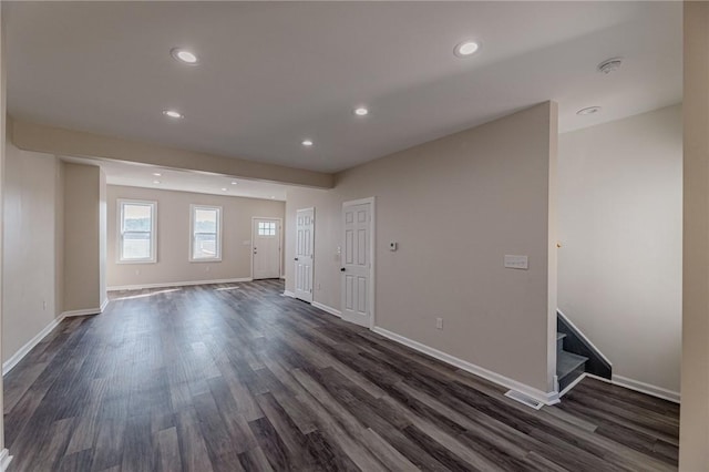 unfurnished room with dark wood-type flooring