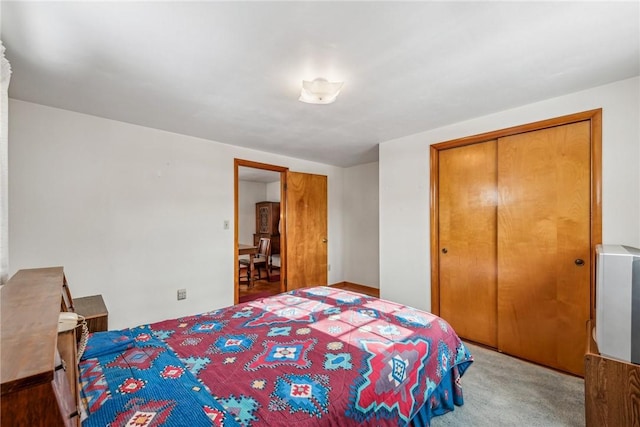 bedroom with light carpet and a closet