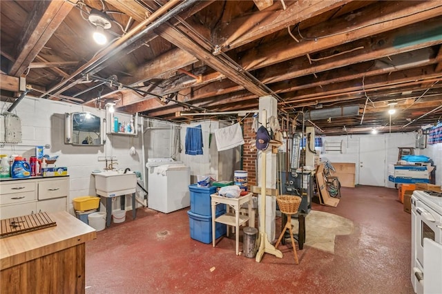 basement with washer and clothes dryer and sink