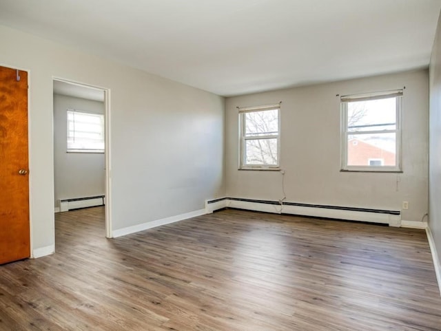 spare room with light hardwood / wood-style flooring and a baseboard radiator