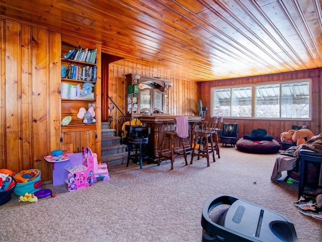 recreation room featuring carpet, wood ceiling, wooden walls, and bar