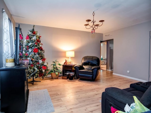 living room featuring light hardwood / wood-style floors and an inviting chandelier