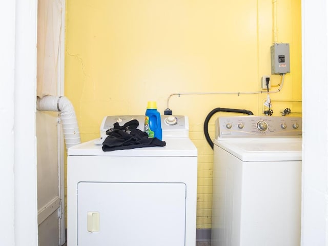 clothes washing area featuring washing machine and dryer and electric panel