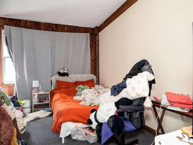 bedroom with a textured ceiling and carpet floors