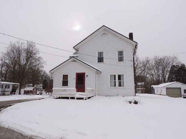 view of snow covered back of property