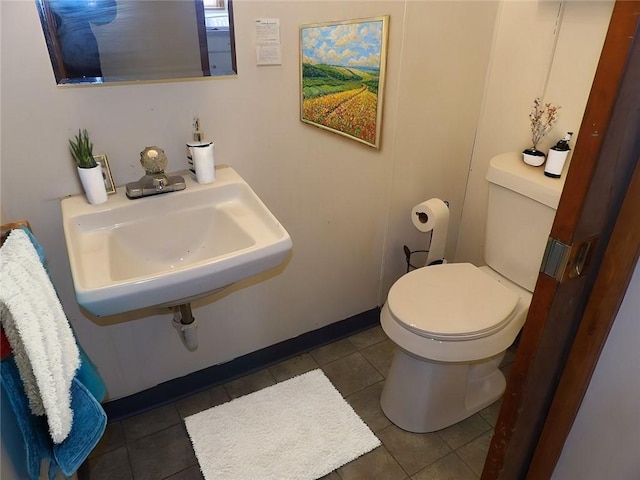 bathroom with tile patterned flooring, toilet, and sink