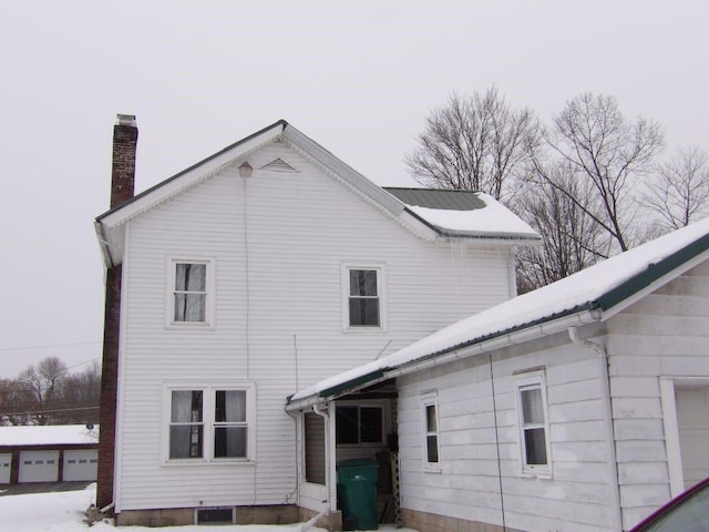 rear view of property featuring a garage