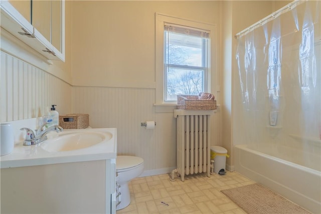 full bathroom featuring radiator heating unit, vanity, toilet, and shower / bath combo with shower curtain