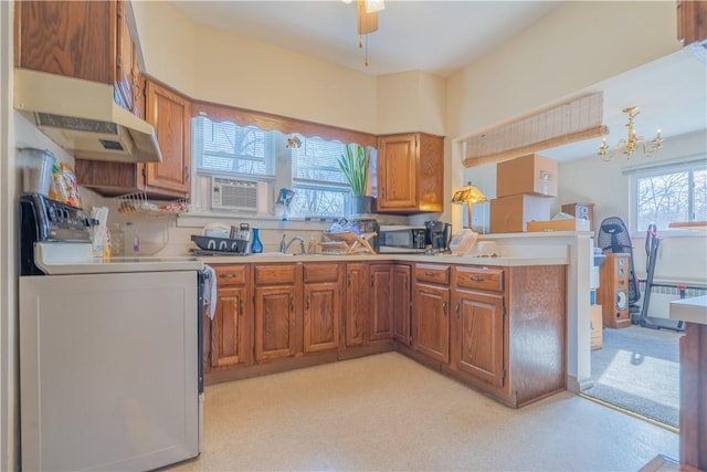 kitchen with ceiling fan with notable chandelier and range with electric stovetop