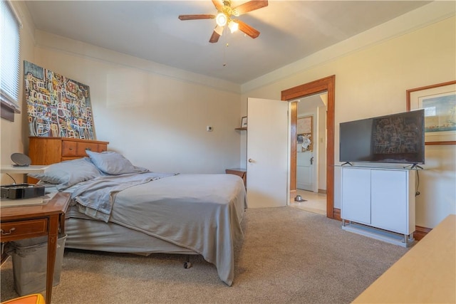 carpeted bedroom featuring ceiling fan and crown molding