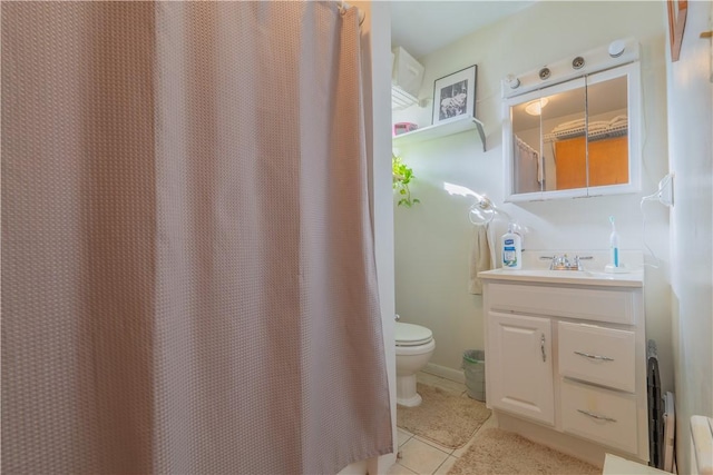 bathroom featuring tile patterned flooring, vanity, and toilet