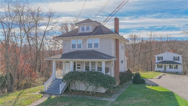 view of front facade with covered porch and a front yard