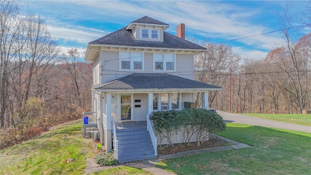 view of front of house with a porch and a front lawn