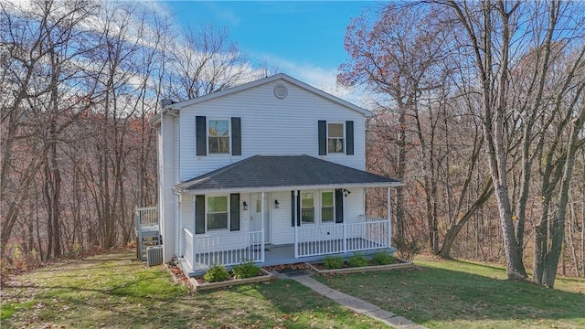 view of front of property with central AC, covered porch, and a front yard