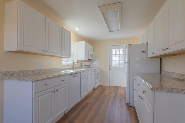 kitchen featuring white cabinets, white appliances, sink, and light hardwood / wood-style flooring