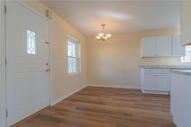 interior space featuring hardwood / wood-style floors and a chandelier