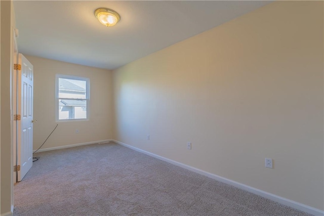 unfurnished room with light carpet