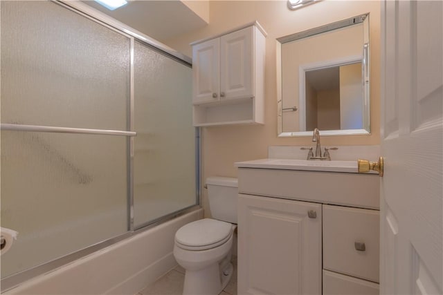 full bathroom with tile patterned flooring, vanity, toilet, and bath / shower combo with glass door