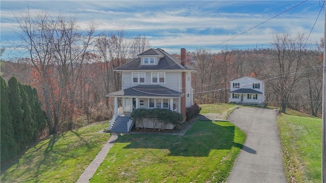 view of front of home featuring a front yard and a porch