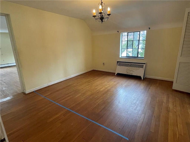 unfurnished living room featuring hardwood / wood-style flooring, a chandelier, radiator, lofted ceiling, and a baseboard heating unit