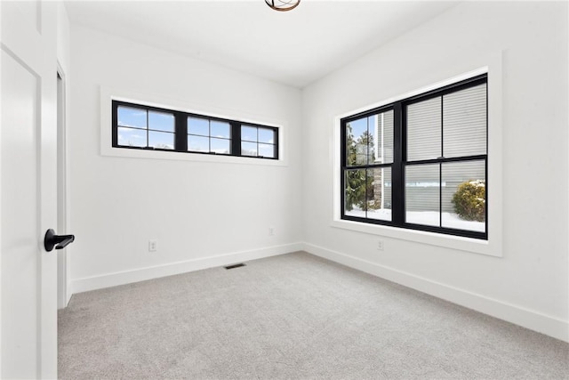 unfurnished room featuring light carpet