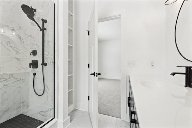 bathroom featuring a tile shower and vanity