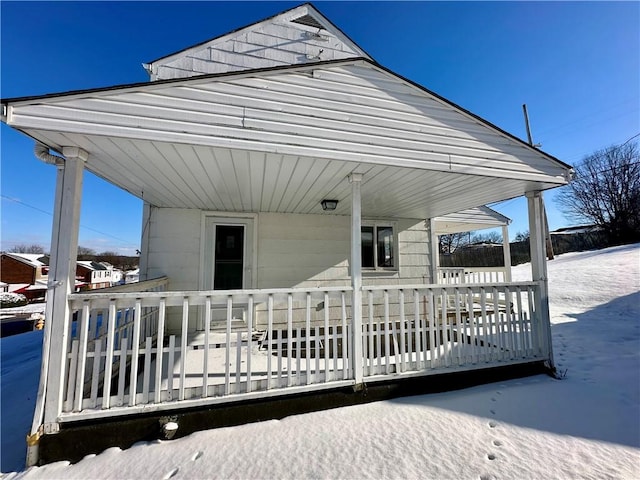 snow covered deck with covered porch